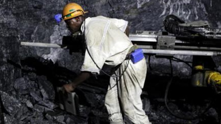 A mine worker is seen underground in South Deep mine outside Johannesburg June 4,2010.