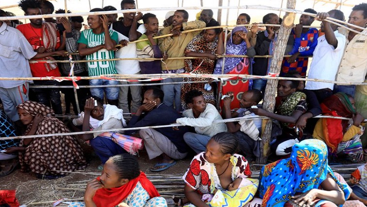 Ethiopians who fled the ongoing fighting in Tigray region gather to receive relief aid at the Um-Rakoba camp on the Sudan-Ethiopia border, in Kassala state, Sudan December 17, 2020.
