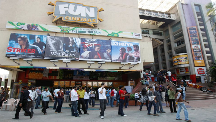 People gather outside a cinema hall to buy tickets for Bollywood films in Mumbai February 12, 2010.