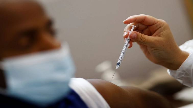 A medical worker administers a dose of the "Comirnaty" Pfizer BioNTech COVID-19 vaccine to a patient in a vaccination center in Nantes, France, October 6, 2021.