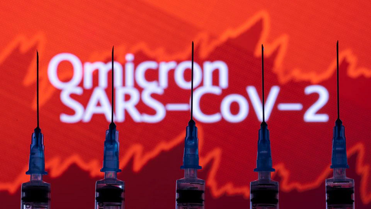 Syringes with needles are seen in front of a displayed stock graph and words "Omicron SARS-CoV-2" in this illustration taken, November 27, 2021. REUTERS/Dado Ruvic/Illustration/file photo