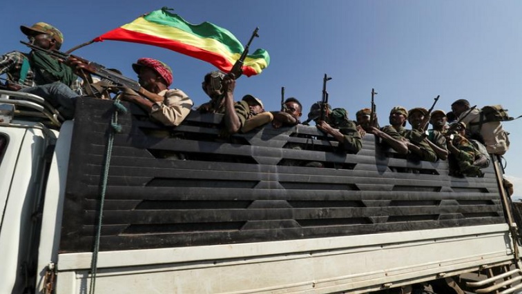 Members of Amhara region militias ride on their truck as they head to face the Tigray People's Liberation Front (TPLF), in Sanja, Amhara region near a border with Tigray, Ethiopia November 9, 2020.