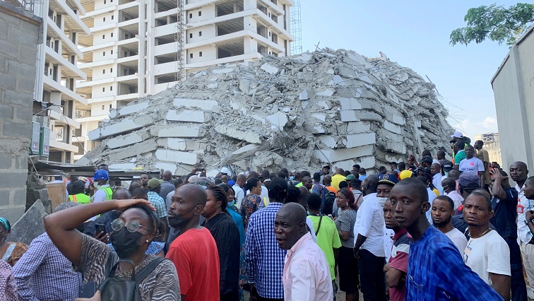 People gather at the site of a collapsed 21-story building in Ikoyi, Lagos, Nigeria, November 1, 2021.