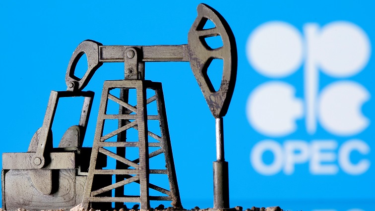 A 3D printed oil pump jack is seen in front of displayed Opec logo in this illustration picture. [File image]