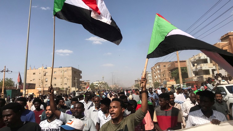 Protesters hold flags and chant slogans as they march against the Sudanese military's recent seizure of power and ousting of the civilian government, in the streets of the capital Khartoum, Sudan [File image]