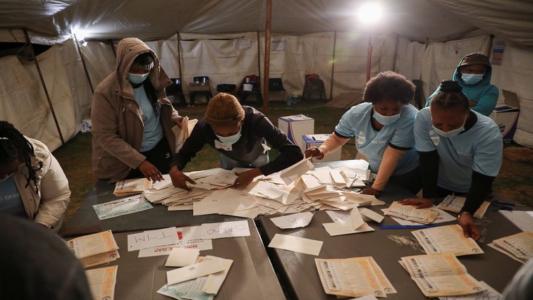 Election officials count ballots after the closing of the local government elections, at a farm in Alewynspoort, outside Johannesburg.