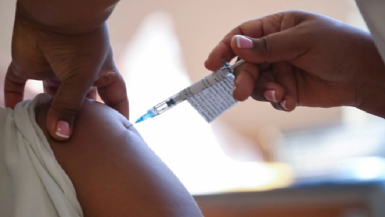 A health worker administers the coronavirus vaccine on a patient.