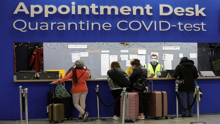 People wait in front of an "Appointment Desk" for quarantine and coronavirus disease (COVID-19) test appointments inside Schiphol Airport, after Dutch health authorities said that 61 people who arrived in Amsterdam on flights from South Africa tested positive for COVID-19, in Amsterdam, Netherlands, November 27, 2021.