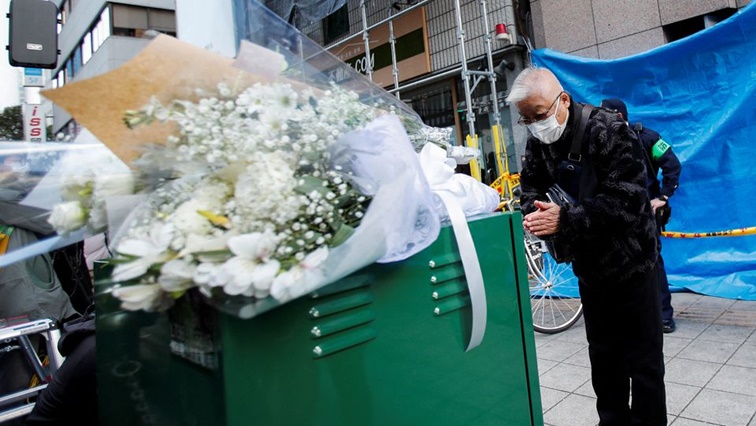 A man bows as he mourns for the victims in front of a building where a fire broke out, in Osaka, Japan December 18, 2021. REUTERS/Kim Kyung-Hoon