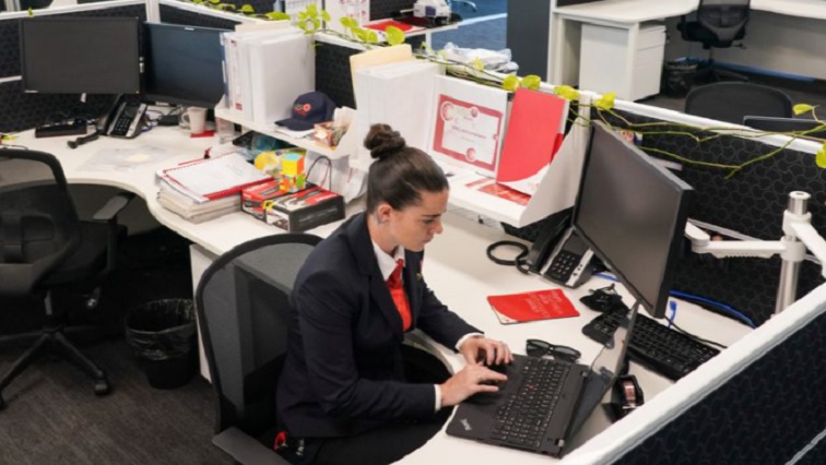 A woman working in an almost empty office following an extended coronavirus disease (COVID-19) lockdown in Sydney, Australia, October 26, 2021.