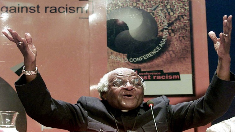 Nobel Peace laureate Archbishop Desmond Tutu gestures as he addresses journalists at the World Conference Against Racism (WCAR), September 5, 2001. Tutu made a call for reparations for slavery saying that they would be like a balm to the wounds of Africa's past.
