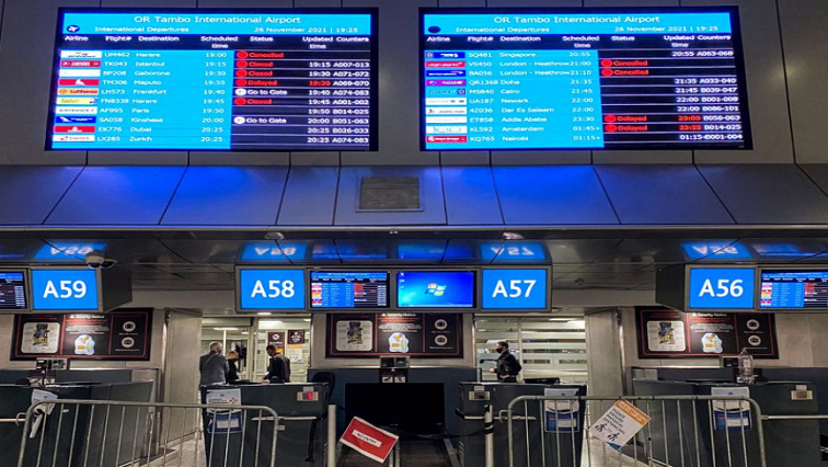Digital display boards show cancelled flights to London's Heathrow at O.R. Tambo International Airport in Johannesburg, South Africa, November 26, 2021.