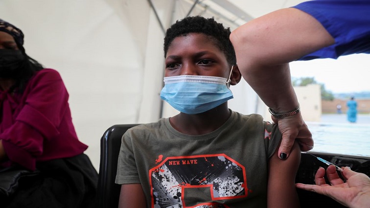 A healthcare worker administers the Pfizer coronavirus disease (COVID-19) vaccine to Simphiwe, 13, amidst the spread of the SARS-CoV-2 variant Omicron in Johannesburg, South Africa, December 04, 2021.