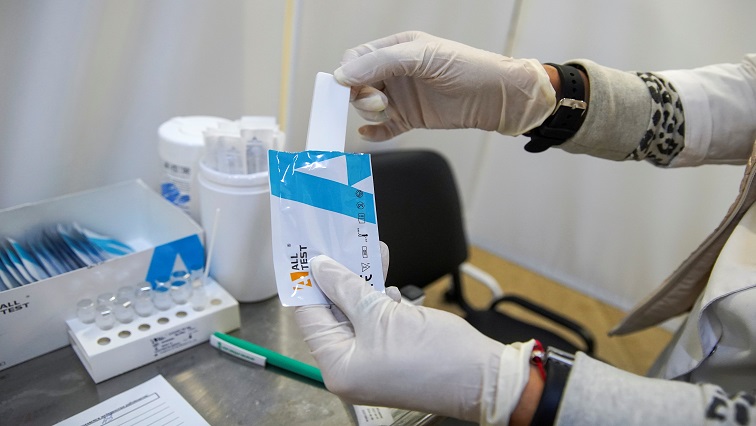 A medical specialist demonstrates a test at a COVID-19 rapid testing centre located at a metro station amid the outbreak of the coronavirus disease.