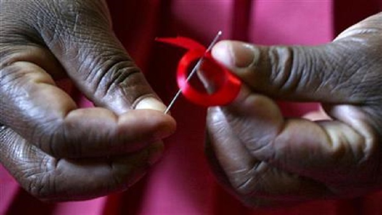 A woman prepares ribbons on World Aids Day at Beacon of Hope centre, a non-government organization formed to address problems facing women.