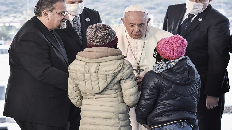 Pope Francis greets two refugee girls at the Reception and Identification Centre (RIC) in Mytilene on the island of Lesbos, Greece, December 5