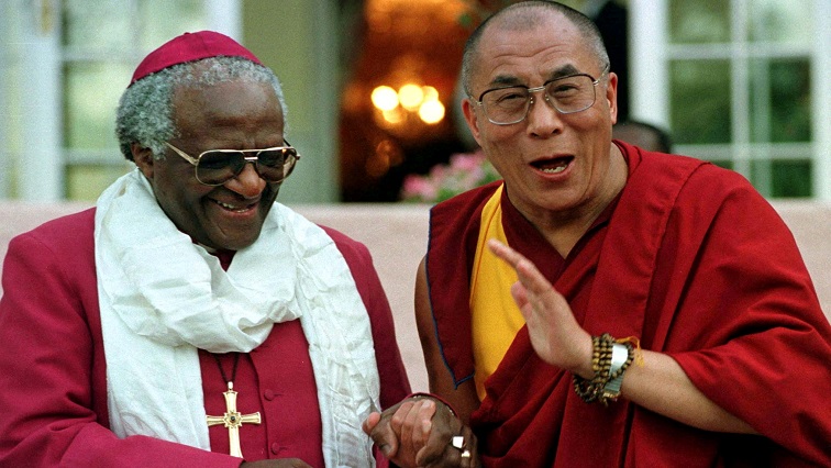 FILE PHOTO: Archbishop Desmond Tutu shares a joke with the Dalai Lama after their meeting, August 21.