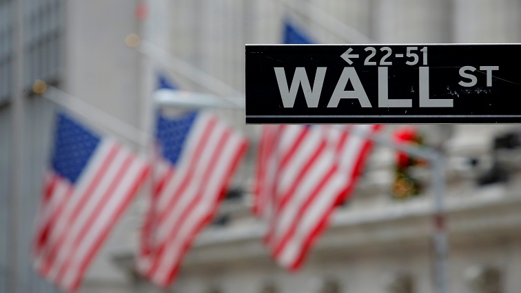 A street sign for Wall Street is seen outside the New York Stock Exchange (NYSE) in Manhattan, New York City