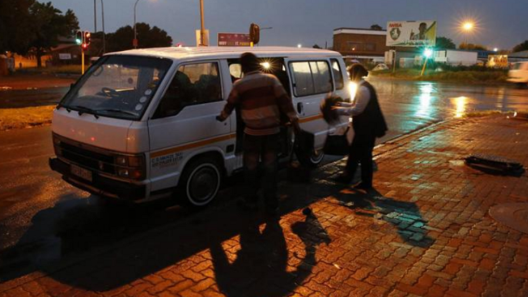 File image: Passengers board a minibus taxi early in the morning in Soweto, South Africa.