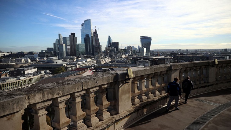People look out to the City of London financial district from a viewing platform in London, Britain, October 22, 2021.