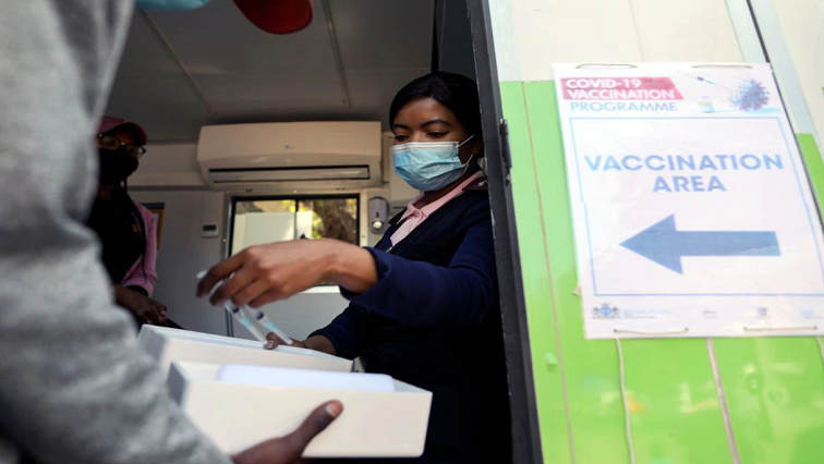 A healthcare worker receives syringes filled with the Johnson and Johnson coronavirus disease (COVID-19) vaccine to be administered in Houghton, Johannesburg, South Africa, August 20, 2021.
