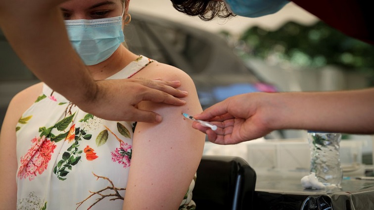 FILE IMAGE: A healthcare worker administers the coronavirus (COVID-19) vaccine to a woman, amidst the spread of the SARS-CoV-2 variant Omicron in Johannesburg, South Africa, December 04, 2021.