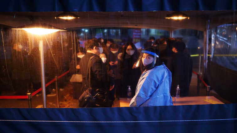 People wait in a line to undergo coronavirus disease (COVID-19) test at its testing site in central Seoul, South Korea, December 1, 2021.