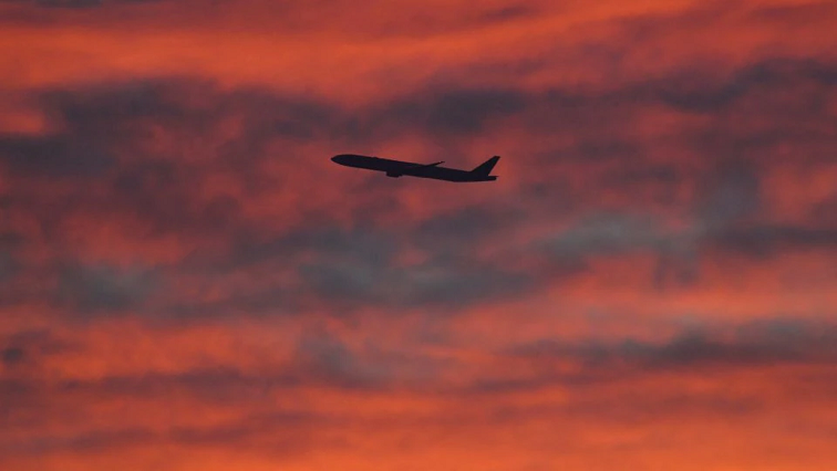 A plane is seen shortly after take-off at sunset, from Heathrow Airport, London, Britain, December 11, 2020.