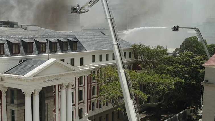 Fire fighters fight the blaze in Parliament, Cape Town.