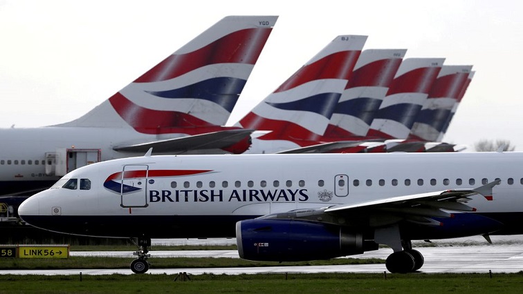 File image: A British Airways plane taxis past tail fins of parked aircraft near Terminal 5 at Heathrow Airport in London, Britain, March 14, 2020.