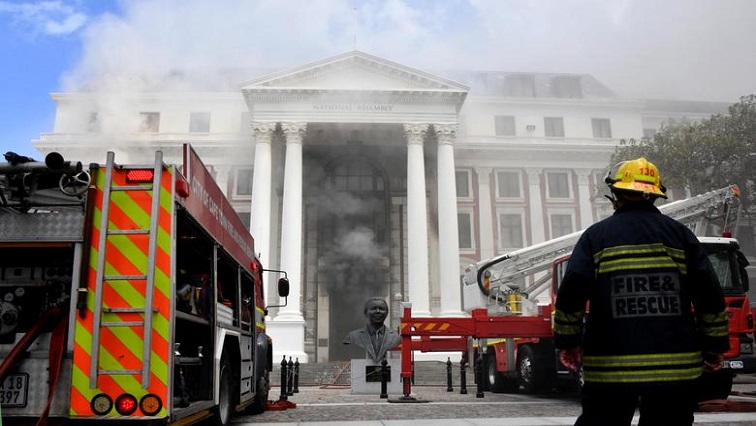 [File Image] A firefighter looks at the smoke rising after a fire broke out in the Parliament in Cape Town, South Africa, January 2, 2022.