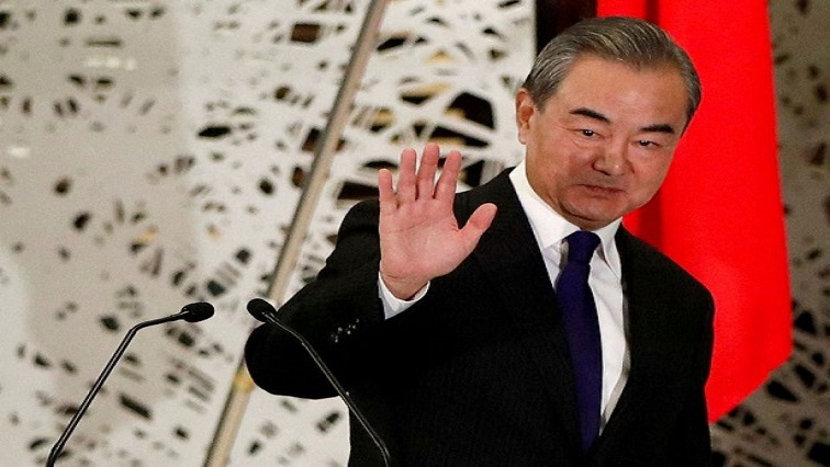 China's Wang Yi, state councillor and foreign minister, waves as he leaves a news conference in Tokyo, Japan, November 24, 2020.