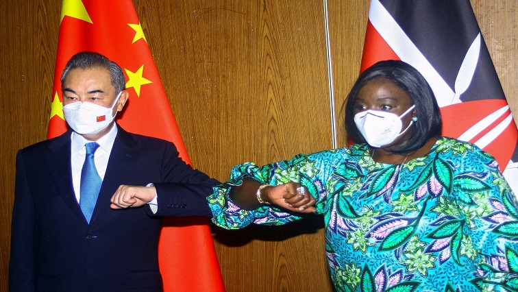 Chinese Foreign Minister Wang Yi and his Kenyan counterpart Raychelle Omamo bump elbows during a news conference in the coastal city of Mombasa, Kenya January 6, 2022.