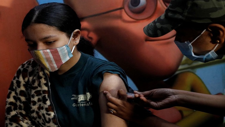 A girl receives a dose of the COVAXIN coronavirus disease (COVID-19) vaccine manufactured by Bharat Biotech, during a vaccination drive for children aged 15-18 in New Delhi, India, January 3, 2022.