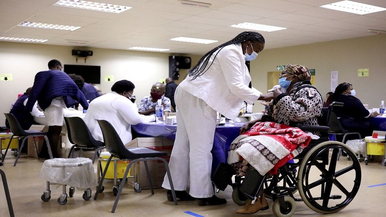 A woman receives a dose of a coronavirus disease (COVID-19) vaccine, as South Africa rolls out the coronavirus disease (COVID-19) vaccination to the elderly at the Munsieville Care for the Aged Centre outside Johannesburg, South Africa May 17, 2021.