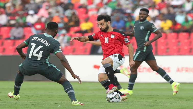 Egypt's Mohamed Salah between two Nigerian players.