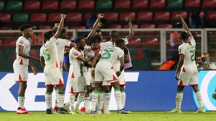 Burkina Faso's Hassane Bande celebrates scoring their first goal with teammates during a match in Cameroon.