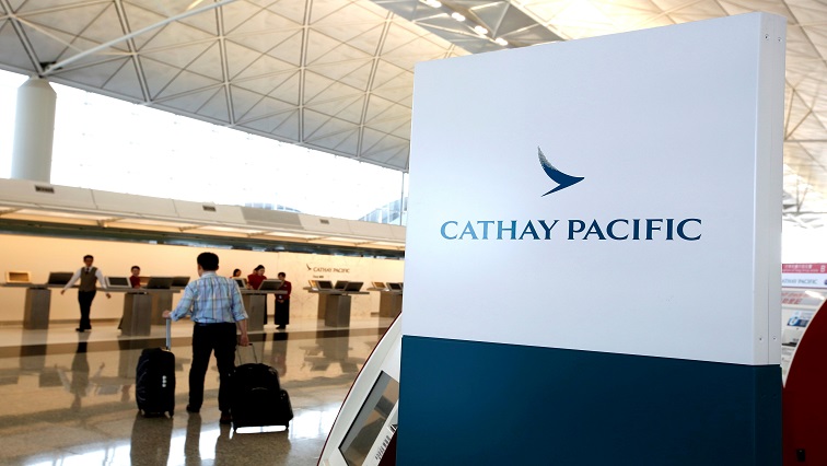 A passenger walks to the First Class counter of Cathay Pacific Airways at Hong Kong Airport [File image]