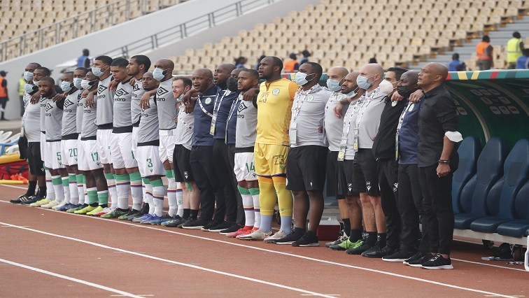 The Comoros bench line up during the national anthems before the match.