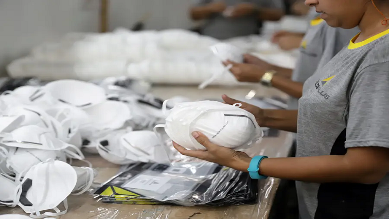 A worker packaging face masks at a PPE factory