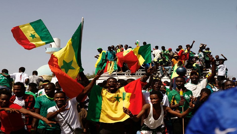 Senegalese fans celebrate as they wait to welcome the Senegal National Soccer Team after their Africa Cup win, in Dakar, Senegal February 7, 2022.