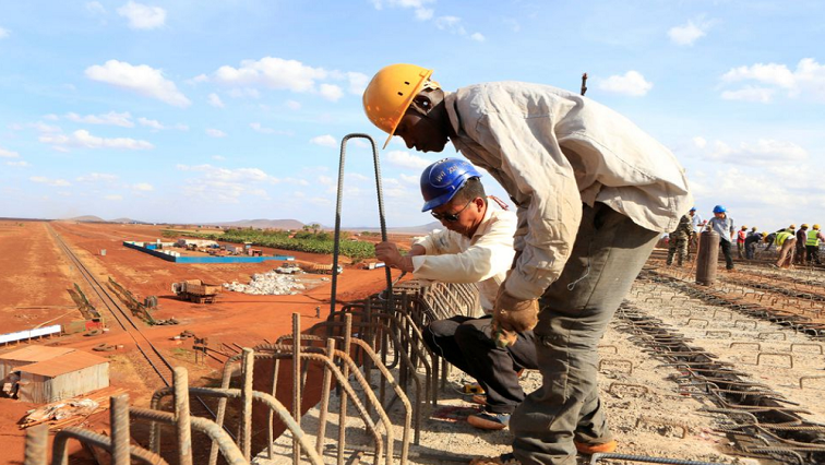 A Chinese engineer and a local construction worker work on a section of the Mombasa-Nairobi standard gauge railway (SGR) in Emali, Kenya October 10, 2015.