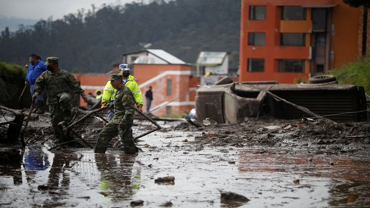 Firefighter rescue crews are seen as they continue searching homes and streets covered by mud in Quito, Ecuador, February 1, 2022.