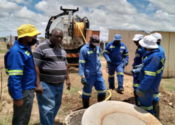 Sol Plaatje Municipality workers unblocking a manhole.