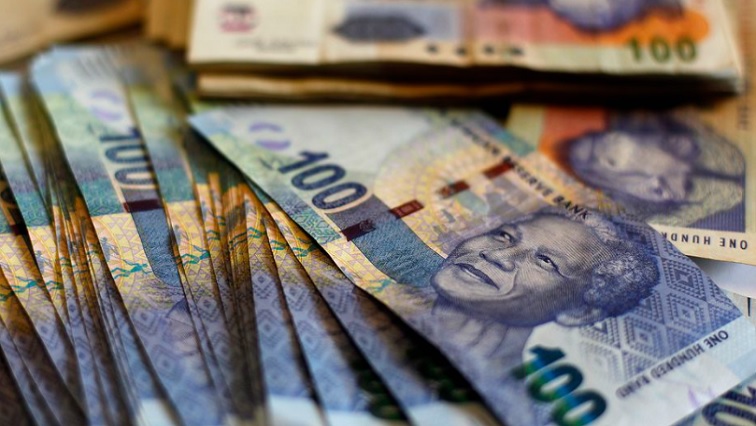 South African bank notes featuring an image of former President Nelson Mandela are displayed at an office in Johannesburg.