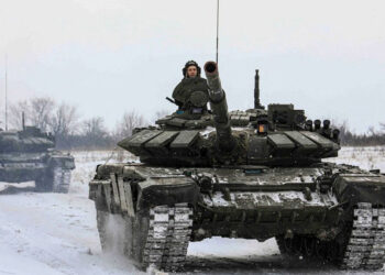 Russian servicemen drive tanks during military exercises in the Leningrad Region, Russia.
