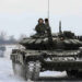 Russian servicemen drive tanks during military exercises in the Leningrad Region, Russia.