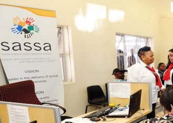 People are seen at the SASSA Mossel Bay offices.
