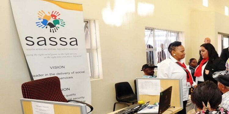 People are seen at the SASSA Mossel Bay offices.