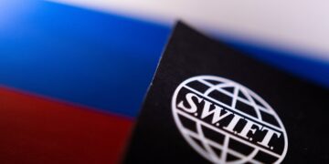 FILE PHOTO: Swift logo is placed on a Russian flag are seen in this illustration taken, Bosnia and Herzegovina, February 25, 2022. REUTERS/Dado Ruvic/Illustration